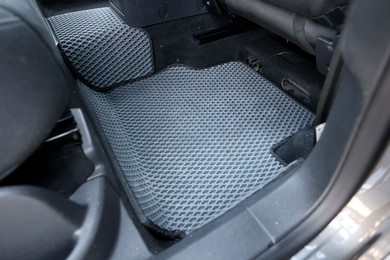 Photo of Grey rubber car floor mat in auto