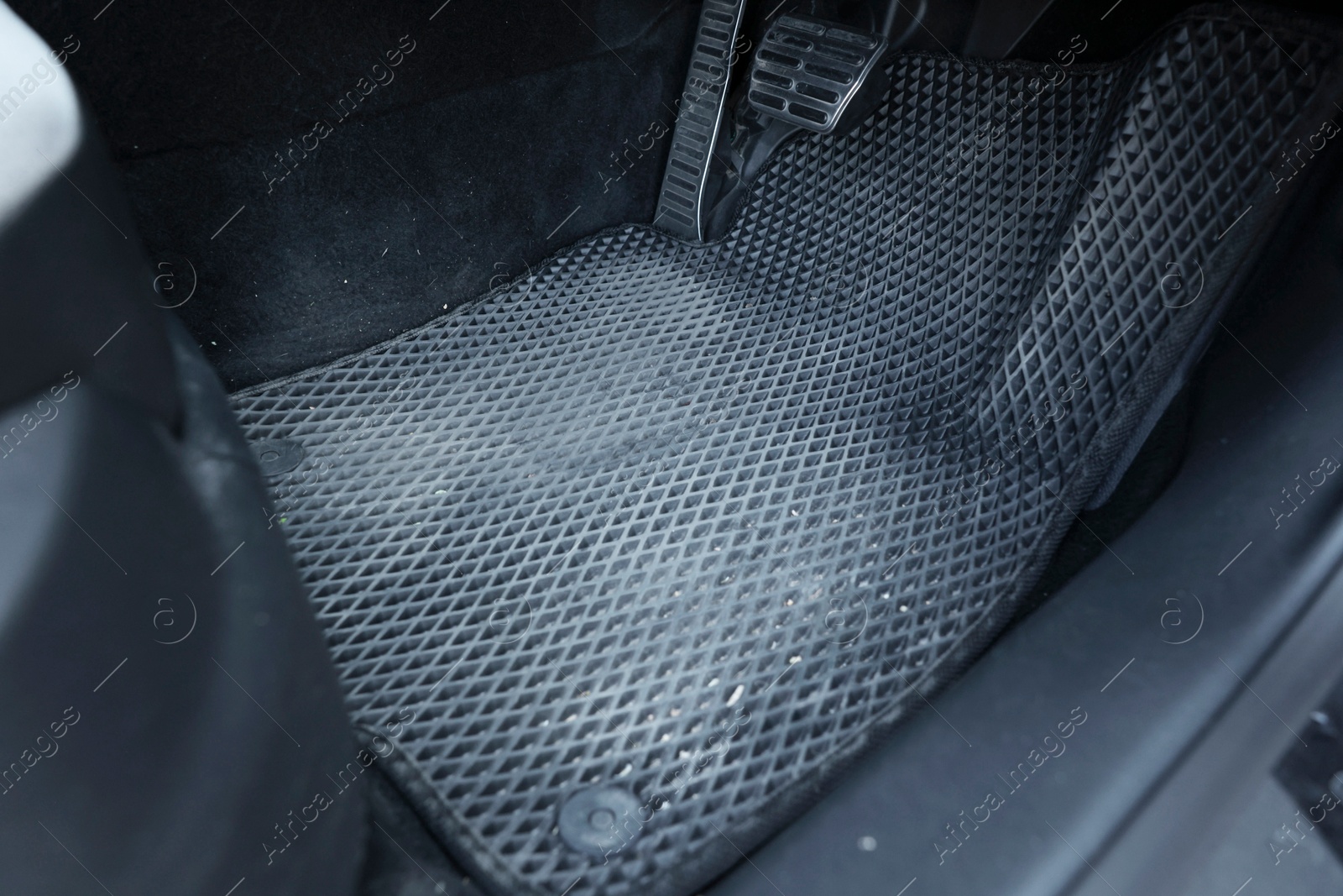 Photo of Dirty grey rubber car mat in auto