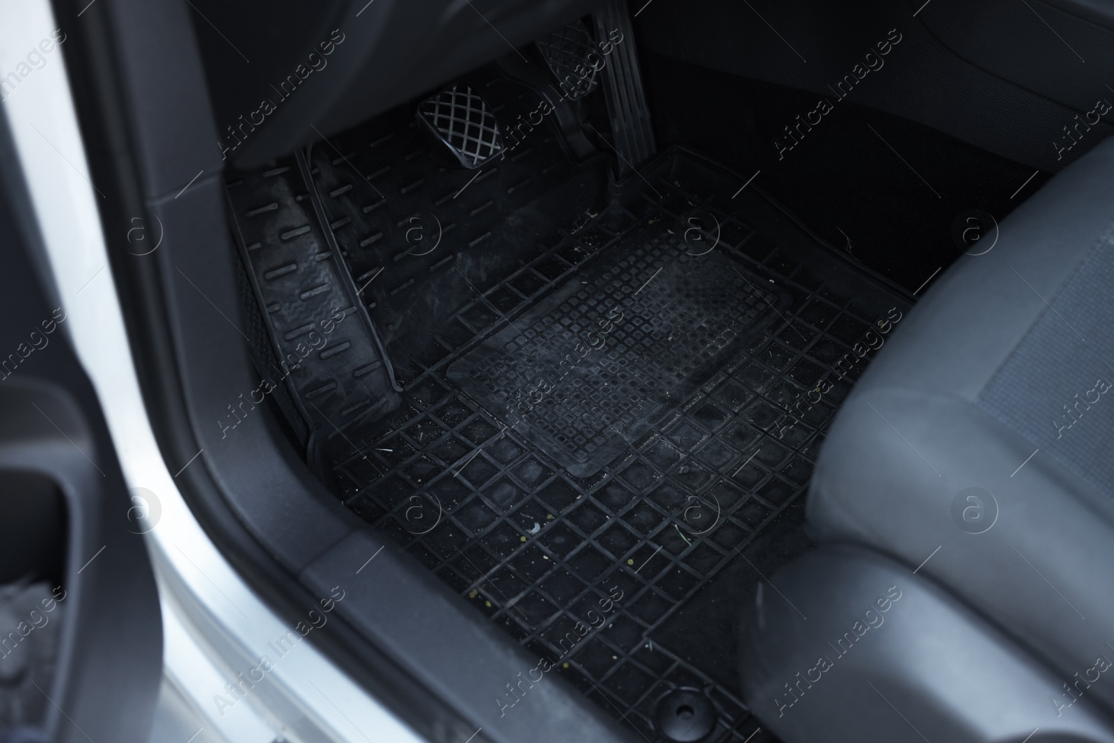 Photo of Black rubber car floor mat in auto