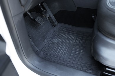 Photo of Black rubber car floor mat in auto