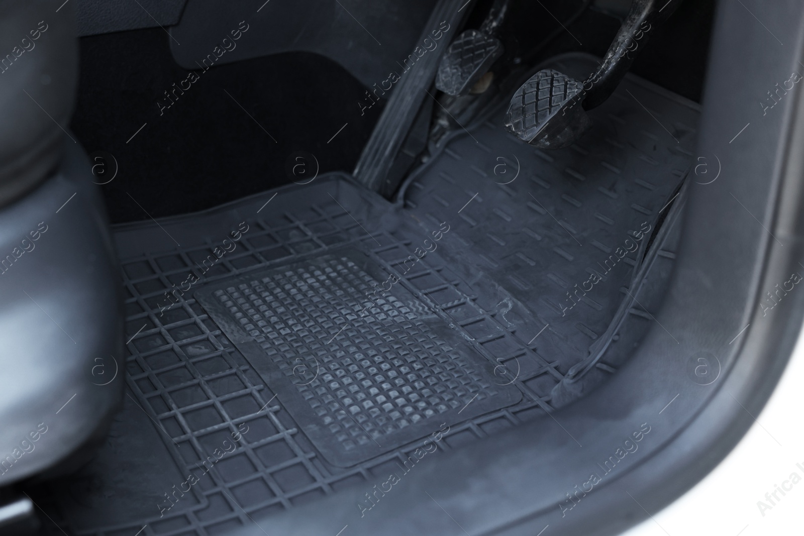 Photo of Black rubber car floor mat in auto