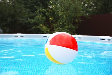 Photo of Inflatable ball floating on water in above ground swimming pool outdoors