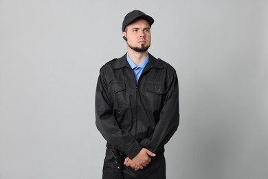 Photo of Security guard in uniform with earpiece on grey background