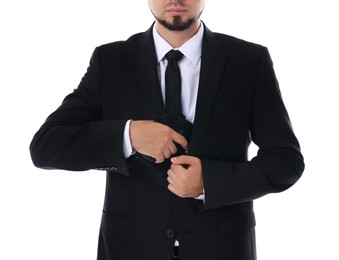 Photo of Young bodyguard in suit with gun isolated on white, closeup