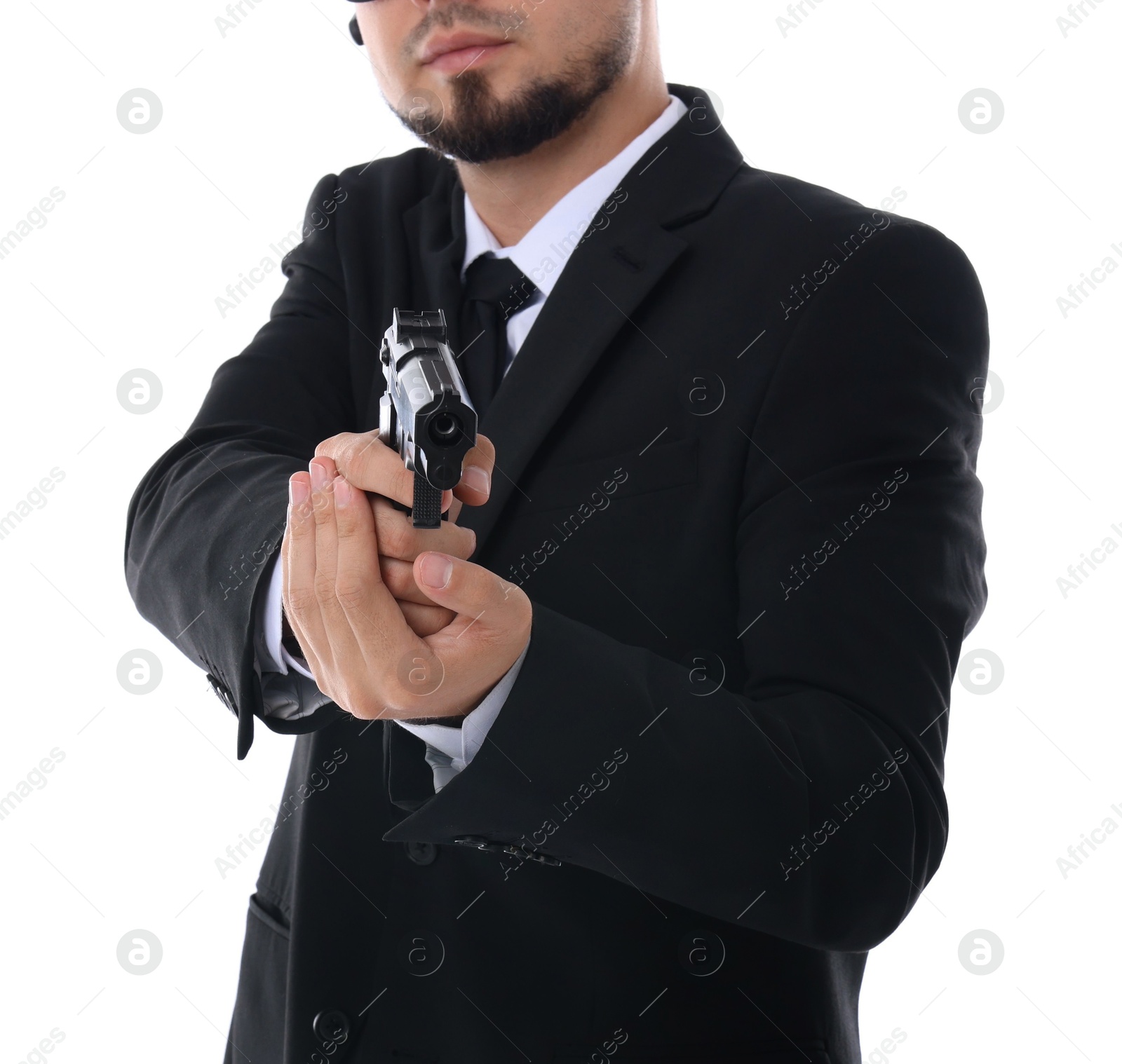 Photo of Young bodyguard in suit using gun on white background, closeup