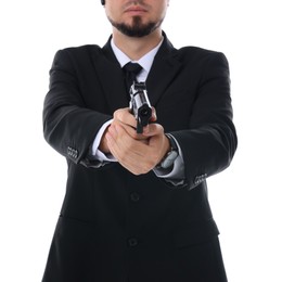 Photo of Young bodyguard in suit using gun on white background, closeup