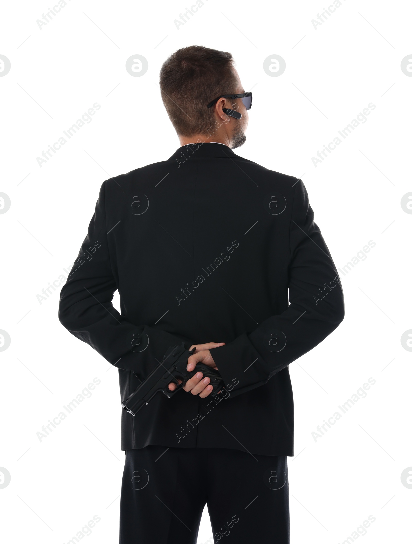 Photo of Bodyguard in suit with gun isolated on white, back view