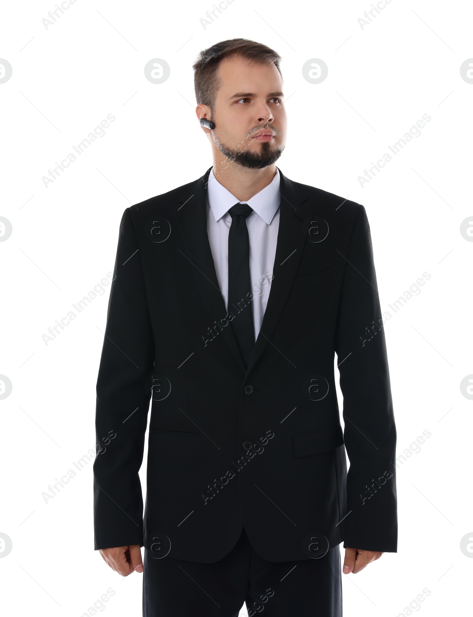 Photo of Young bodyguard in suit with earpiece isolated on white