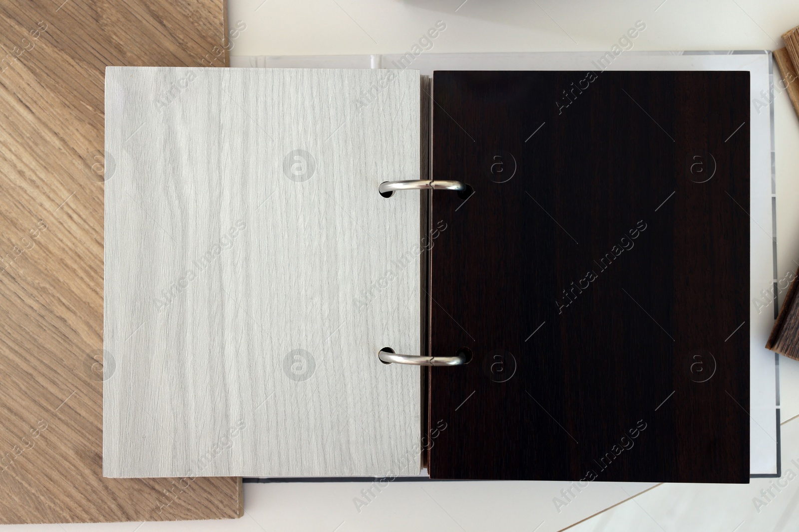 Photo of Different samples of wooden flooring on white table, top view