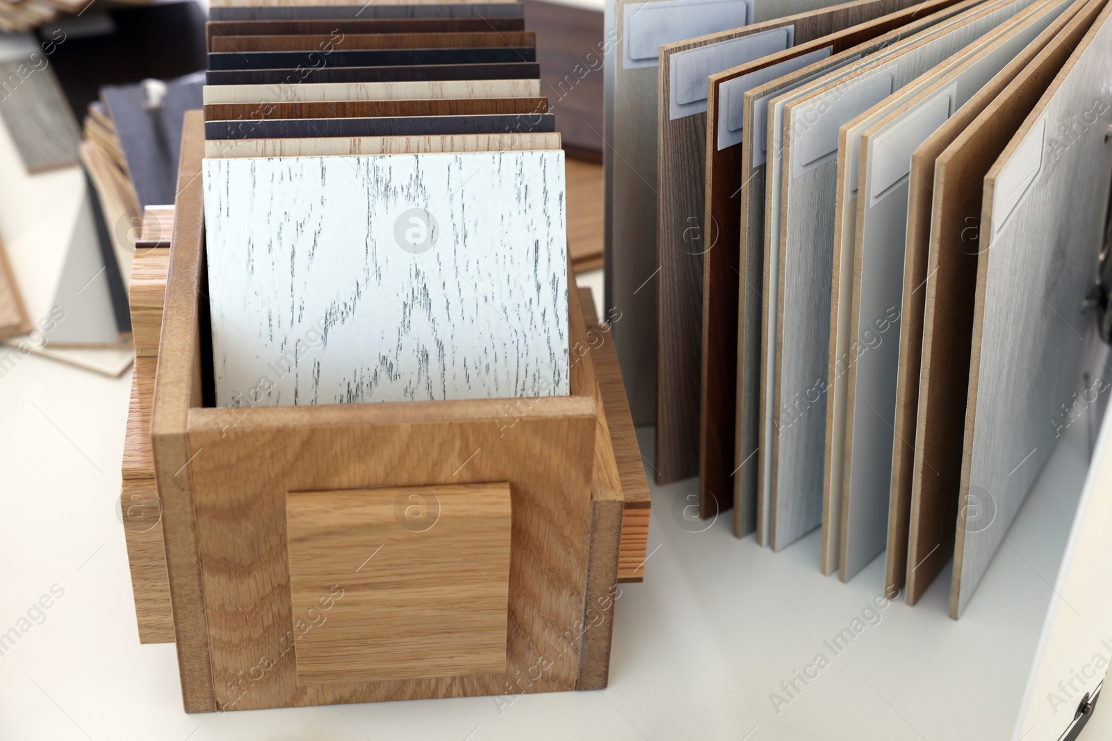 Photo of Different samples of wooden flooring on white table