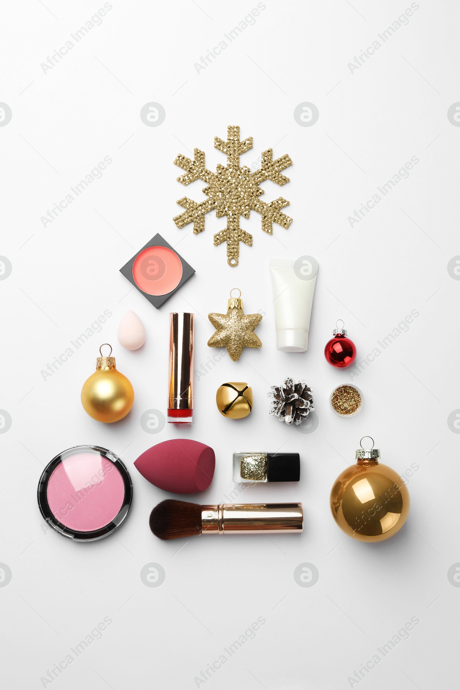 Photo of Christmas tree made of decorative cosmetic products and festive decor on white background, flat lay