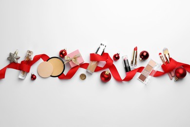 Photo of Different decorative cosmetic products and Christmas decor on white background, flat lay