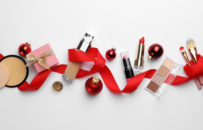 Photo of Different decorative cosmetic products and Christmas decor on white background, flat lay