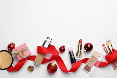 Photo of Different decorative cosmetic products and Christmas decor on white background, flat lay. Space for text