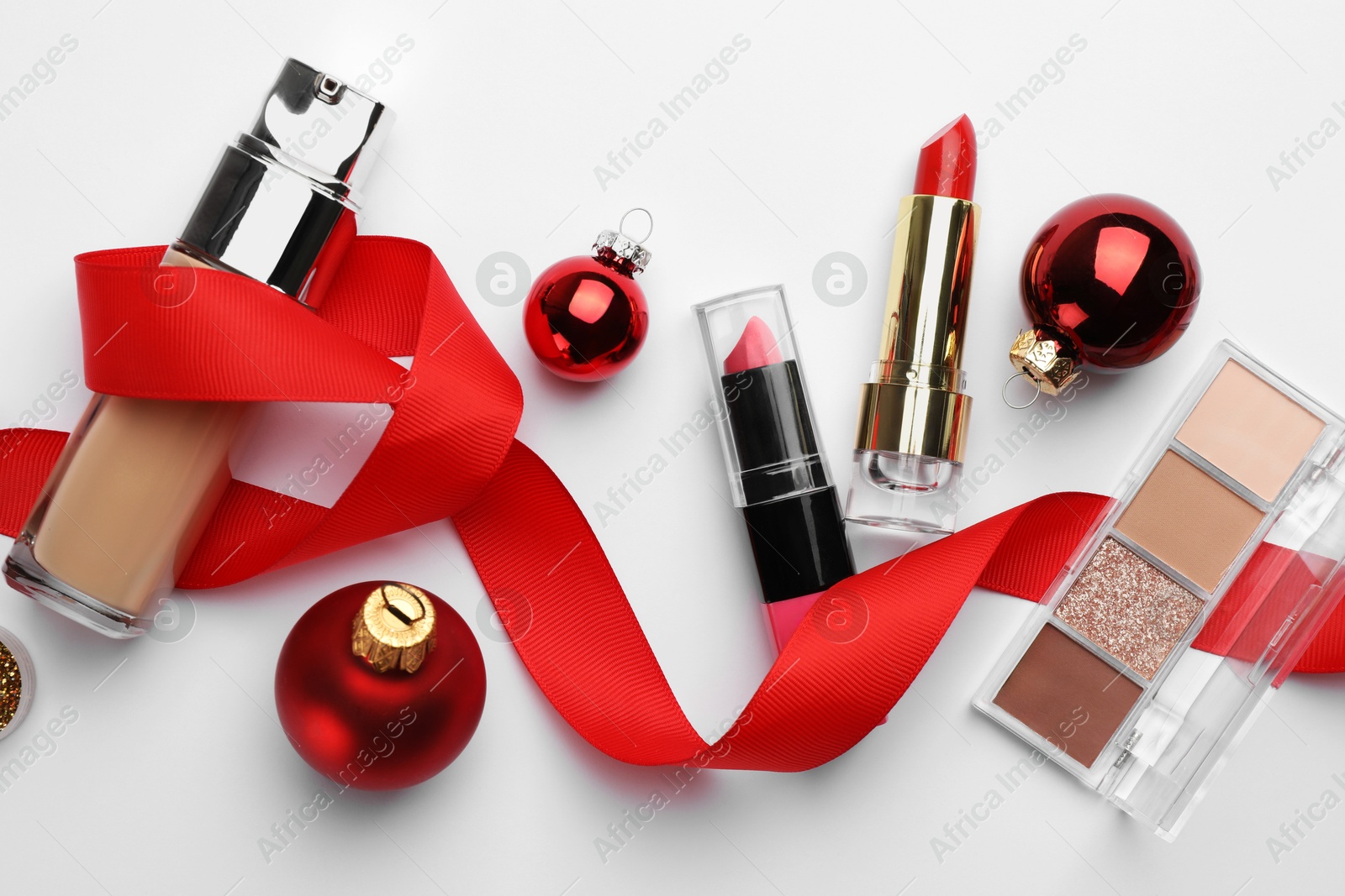 Photo of Different decorative cosmetic products and Christmas decor on white background, flat lay