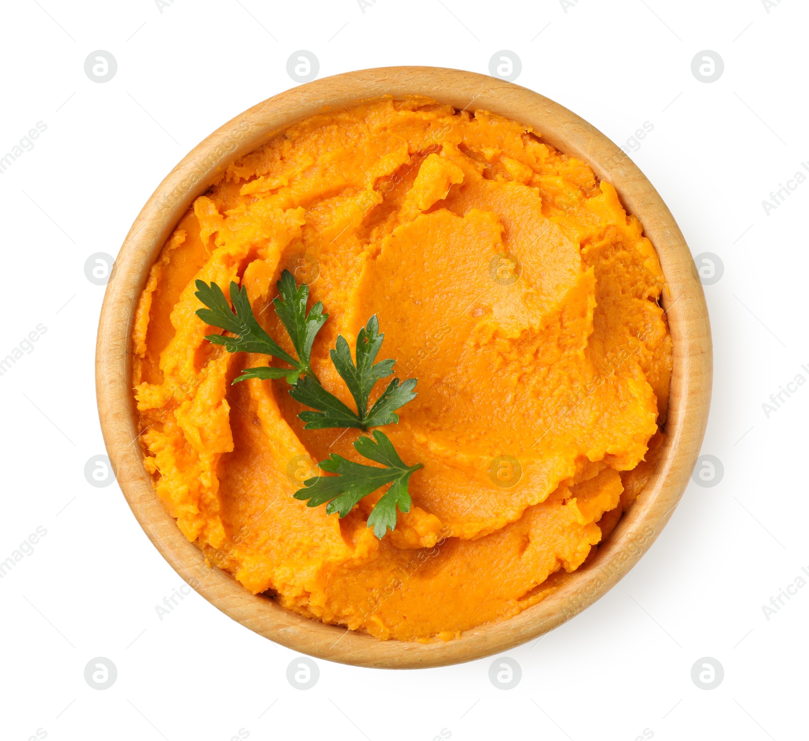 Photo of Tasty mashed sweet potato and parsley in bowl isolated on white, top view