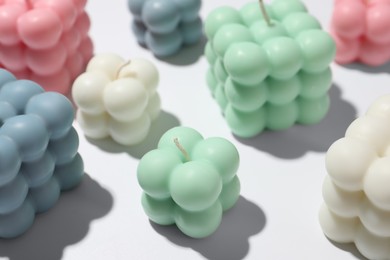 Photo of Beautiful bubble candles on white table, closeup