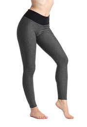 Photo of Woman wearing sports leggings on white background, closeup