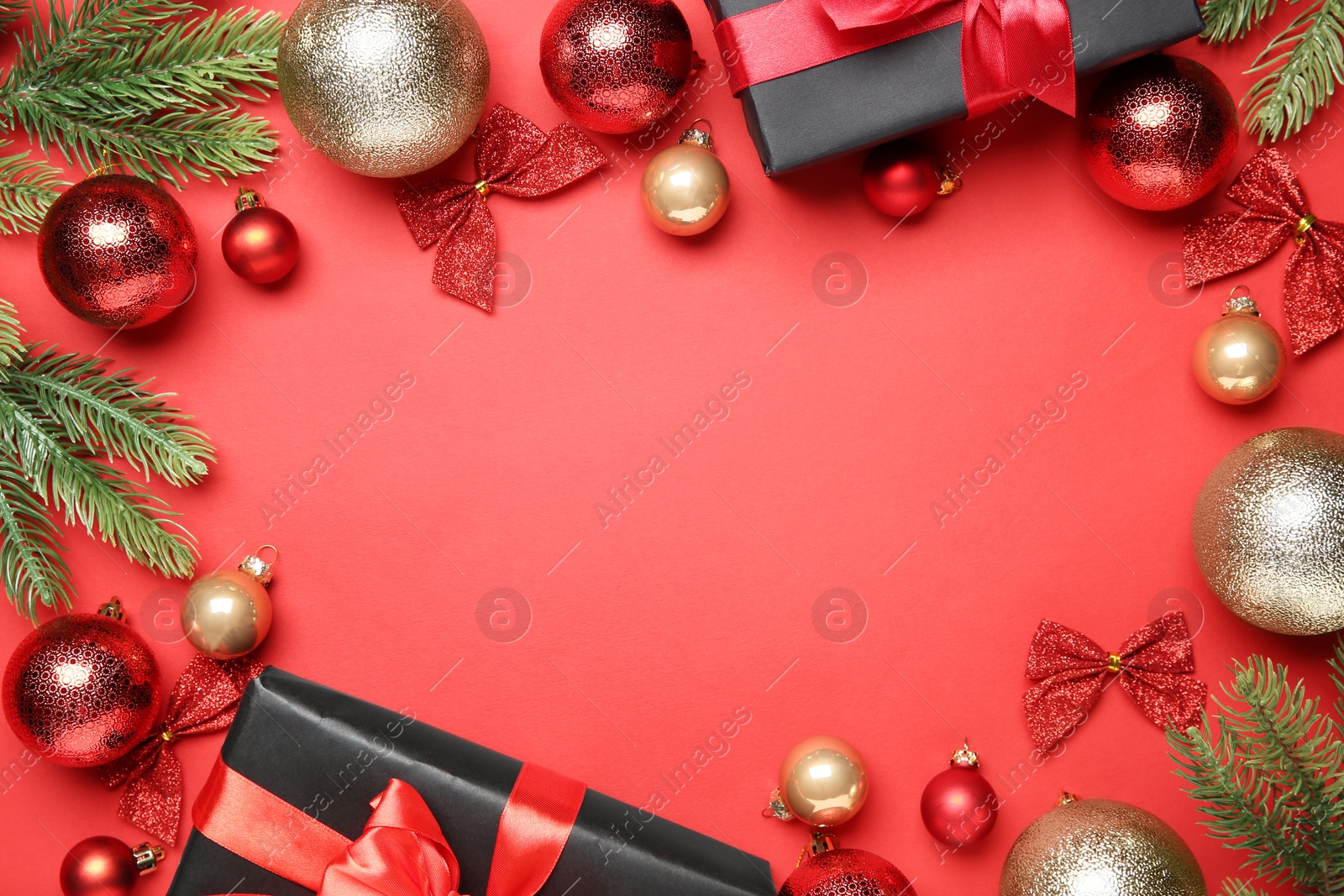 Photo of Flat lay composition with Christmas decor and gift boxes on red background, space for text