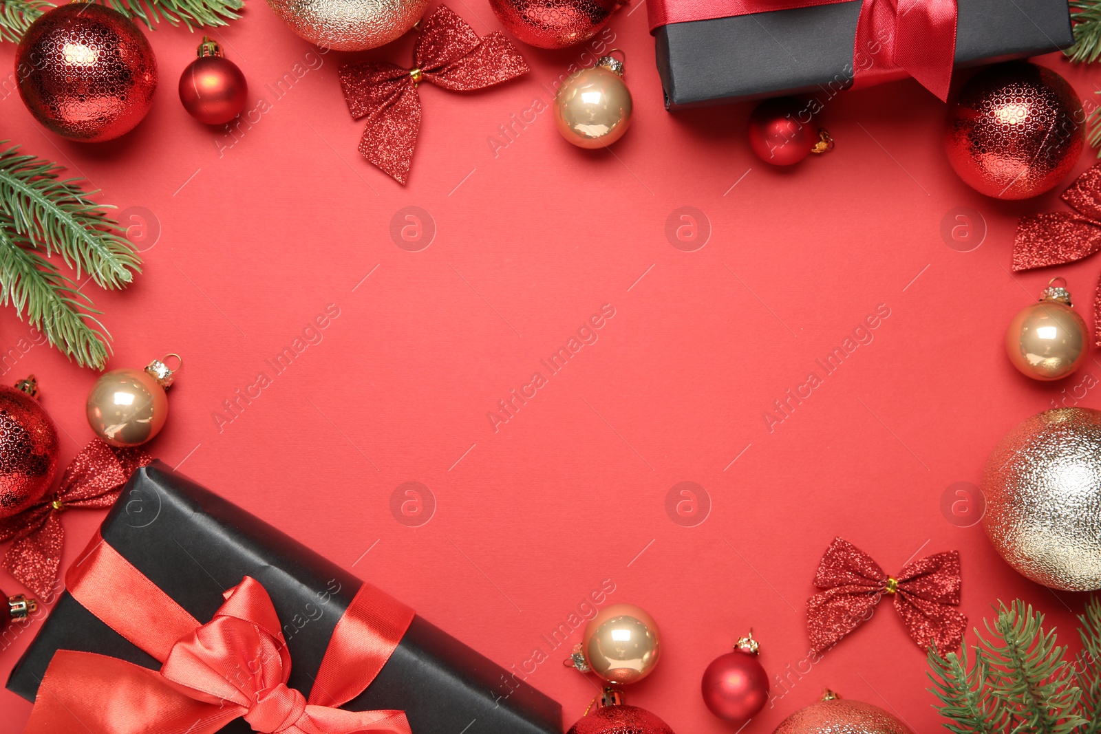 Photo of Flat lay composition with Christmas decor and gift boxes on red background, space for text