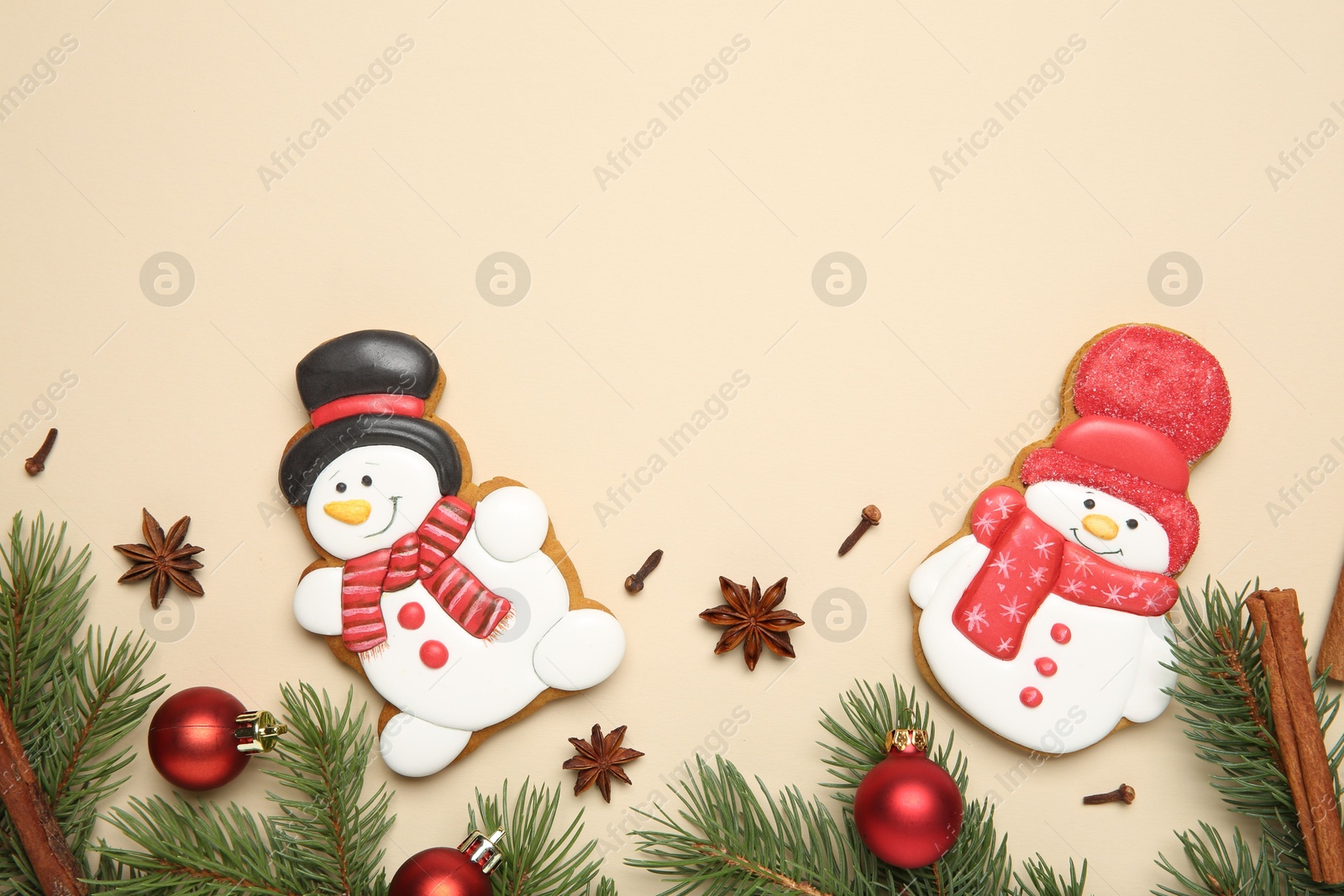 Photo of Flat lay composition with Christmas decor and delicious cookies in shape of snowmen on beige background, space for text