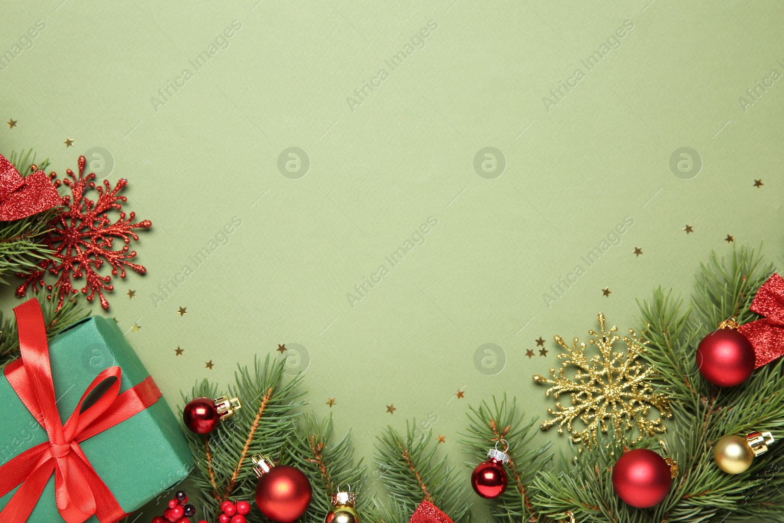 Photo of Flat lay composition with Christmas decor and gift box on green background, space for text