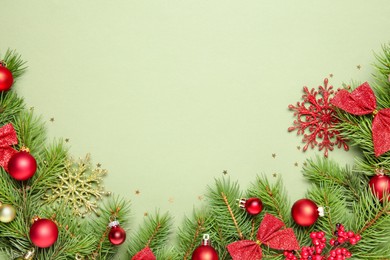 Photo of Flat lay composition with Christmas decor on green background, space for text