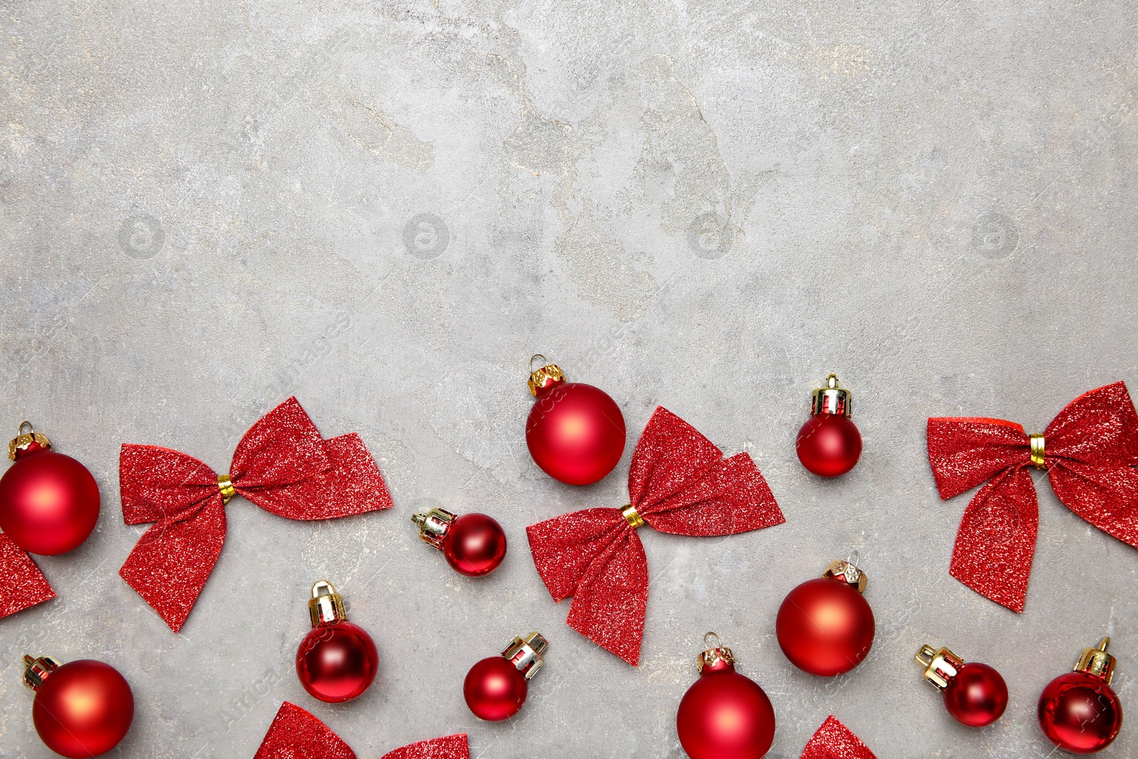 Photo of Flat lay composition with Christmas decor on gray textured table, space for text