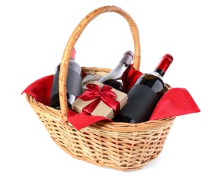 Photo of Wicker gift basket with wine isolated on white