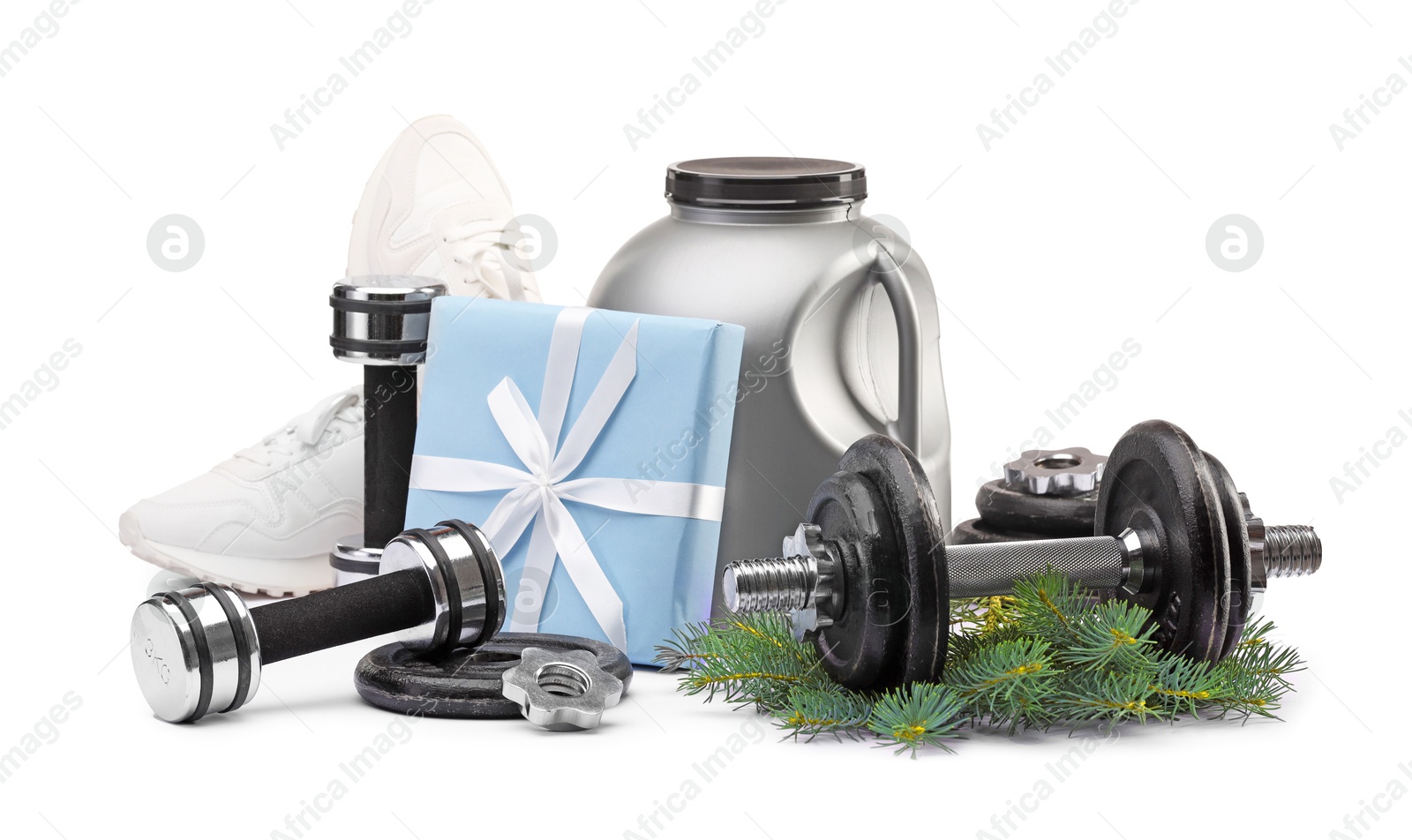 Photo of Dumbbells, container with supplement, sneakers and Christmas decor isolated on white