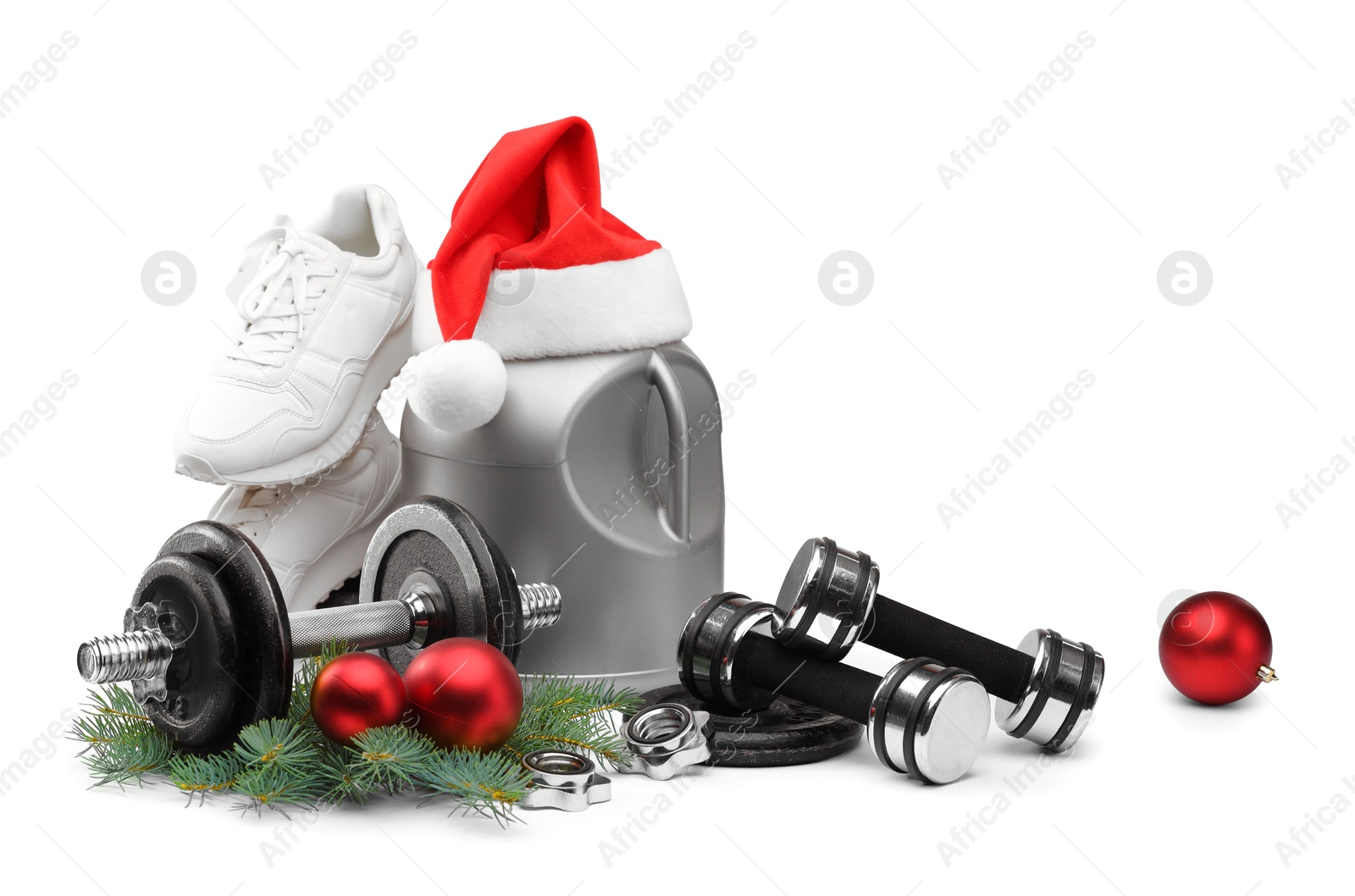 Photo of Dumbbells, container with supplement, sneakers and Christmas decor isolated on white