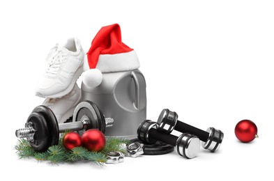 Photo of Dumbbells, container with supplement, sneakers and Christmas decor isolated on white