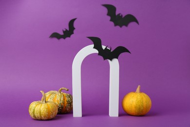 Photo of Presentation of product. Arc and Halloween decor on purple background, space for text