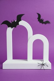 Presentation of product. Arches and Halloween decor on purple background. Space for text