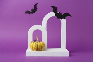 Photo of Presentation of product. Arches and Halloween decor on purple background. Space for text