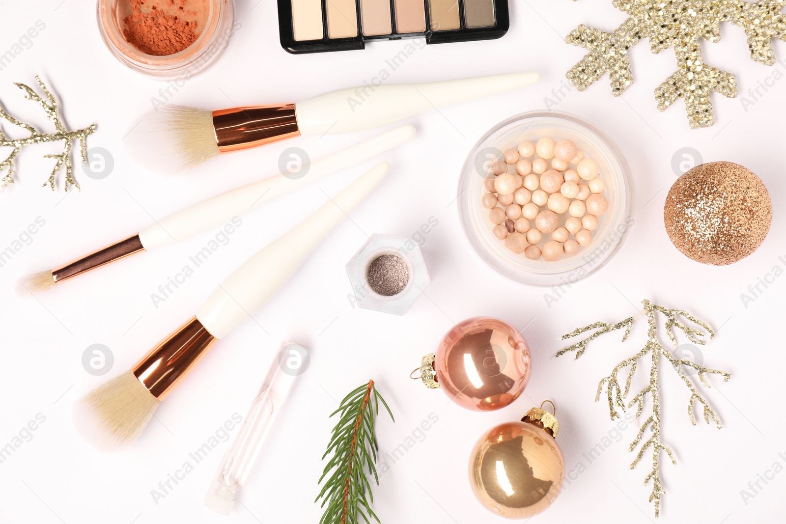 Photo of Different makeup brushes, decorative cosmetics and Christmas decor on white background, flat lay