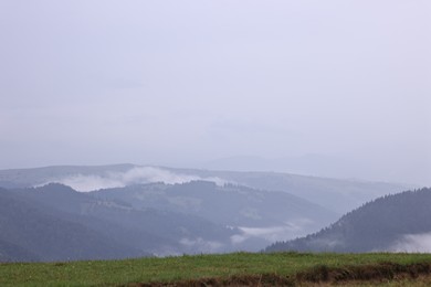 Photo of Picturesque view of beautiful mountains covered with fog