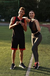 Photo of Happy winners with medals posing at stadium