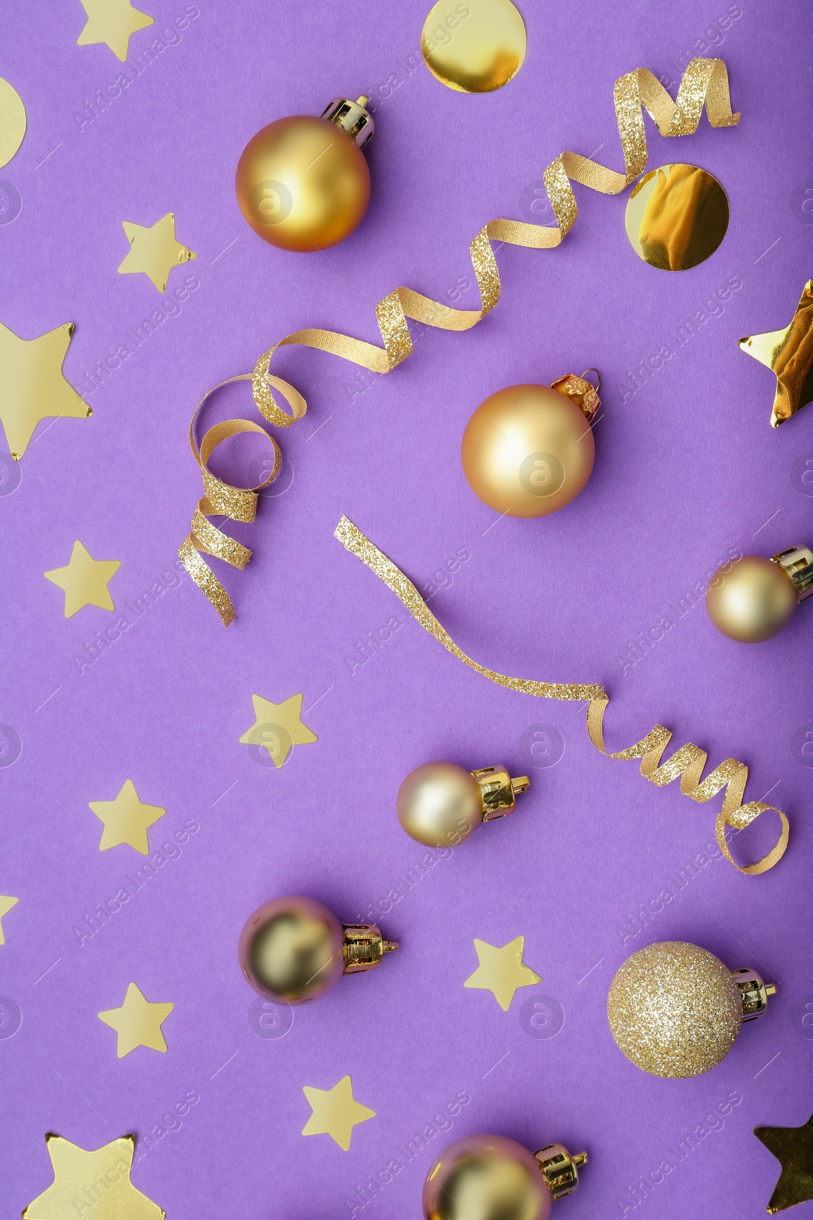 Photo of Beautiful Christmas baubles and confetti on purple background, flat lay