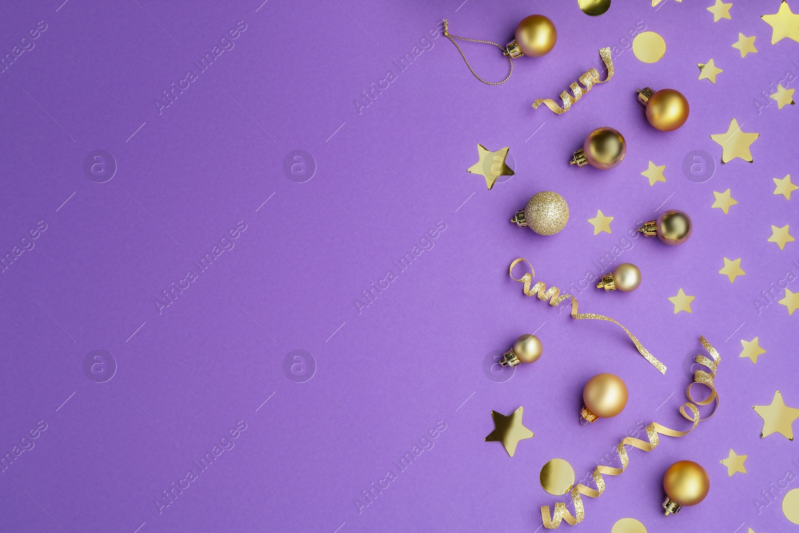 Photo of Beautiful Christmas baubles and confetti on purple background, flat lay. Space for text