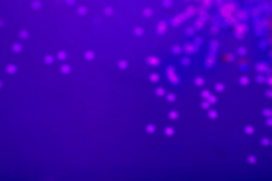 Image of Violet blurred lights on blue gradient backdrop, bokeh effect. Halloween background