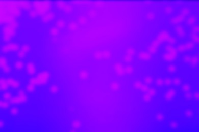 Image of Pink blurred lights on violet blue gradient backdrop, bokeh effect. Halloween background