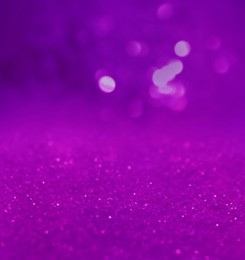 Shiny violet glitter, closeup. Halloween background, bokeh effect