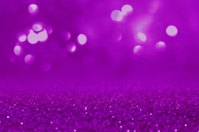 Image of Shiny violet glitter, closeup. Halloween background, bokeh effect