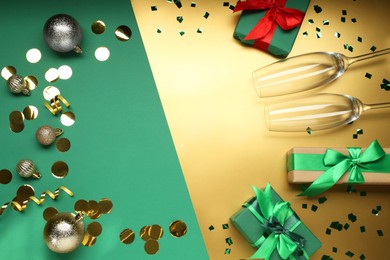 Photo of Flat lay composition with confetti and gift boxes on color background, space for text. Christmas decor