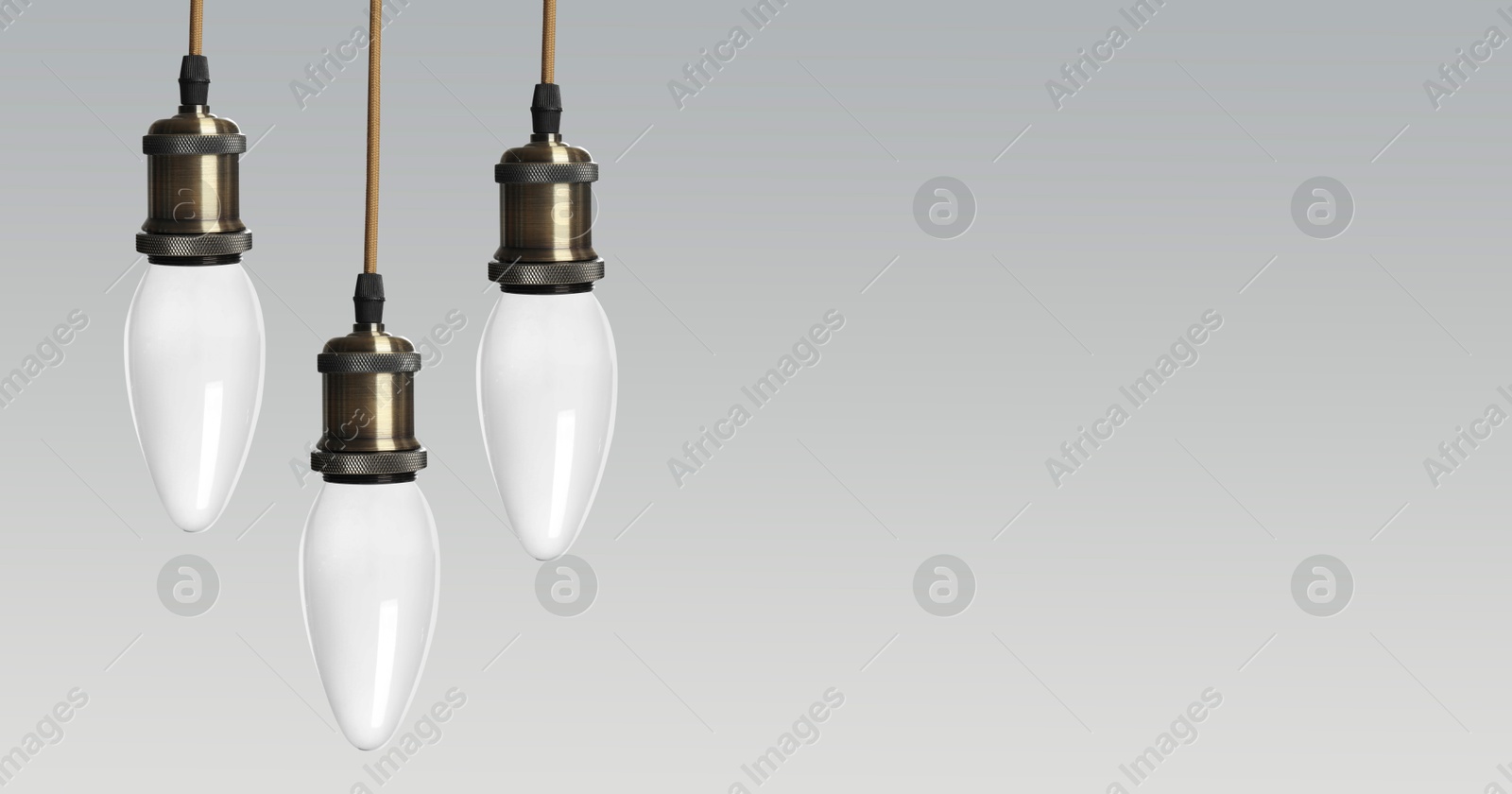 Image of Incandescent light bulbs on gray background, space for text. Banner design