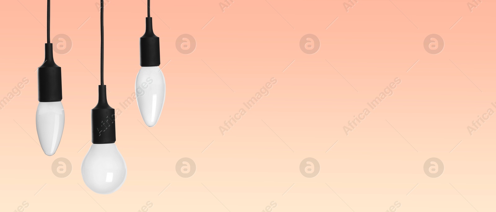 Image of Different incandescent light bulbs on beige gradient background, banner design with space for text