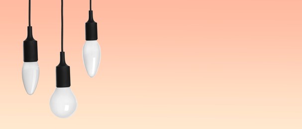 Image of Different incandescent light bulbs on beige gradient background, banner design with space for text