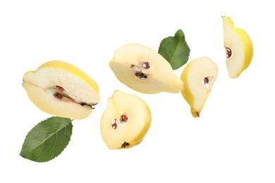 Image of Pieces of fresh quinces and green leaves flying on white background