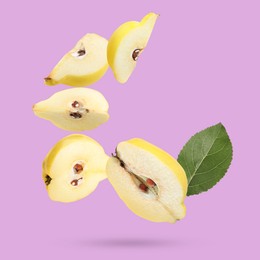 Image of Fresh quinces and green leaves falling on lilac background